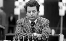 Boris Spassky de traje y corbata mirando abajo pensando y jugando al ajedrez