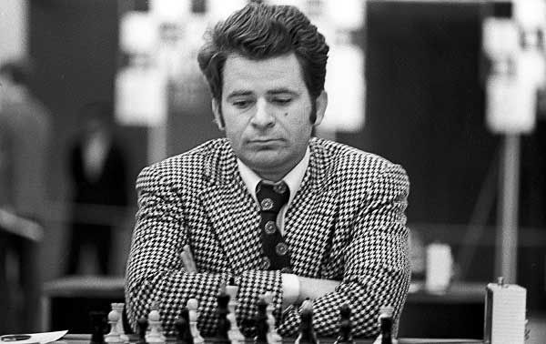 Boris Spassky de traje y corbata mirando abajo pensando y jugando al ajedrez